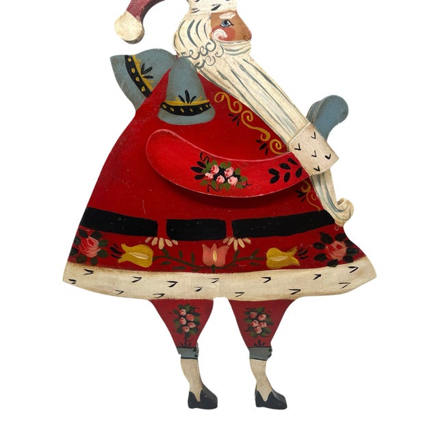 Vintage wooden cut out of Santa/ Saint Nick that has been handpainted. The painting style is much like folk art as it...