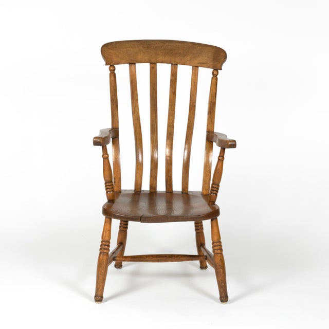 A rustic and charming English elm vertical slat back armchair circa 1890 with turned legs and H-stretcher. height: 39 in....