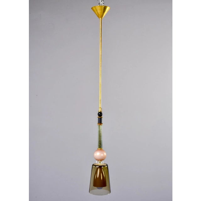 Pair of new Italian glass and brass pendant lights feature multi-color Murano glass elements in shades of green, pink and...