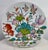 Large white porcelain platter has brighlty colored floral and butterfly pattern. Teal and green fauna, pastel colored fish...