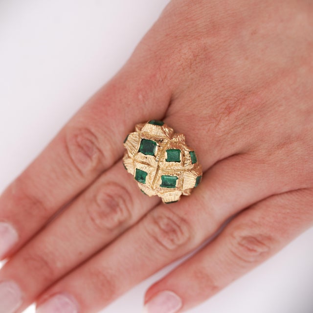 Vintage domed statement ring featuring 3.20 carats of square-cut emeralds set in 18K yellow gold textured basket-weave...