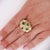 Vintage domed statement ring featuring 3.20 carats of square-cut emeralds set in 18K yellow gold textured basket-weave...