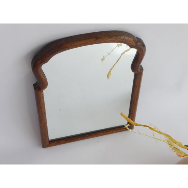 An antique arched wooden mirror with a nice scalloped frame. The mirror dates back to the 19th century and these types of...