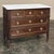 Refined proportions, beautifully grained mahogany, and a luminous white Carrara marble top give this French commode the...