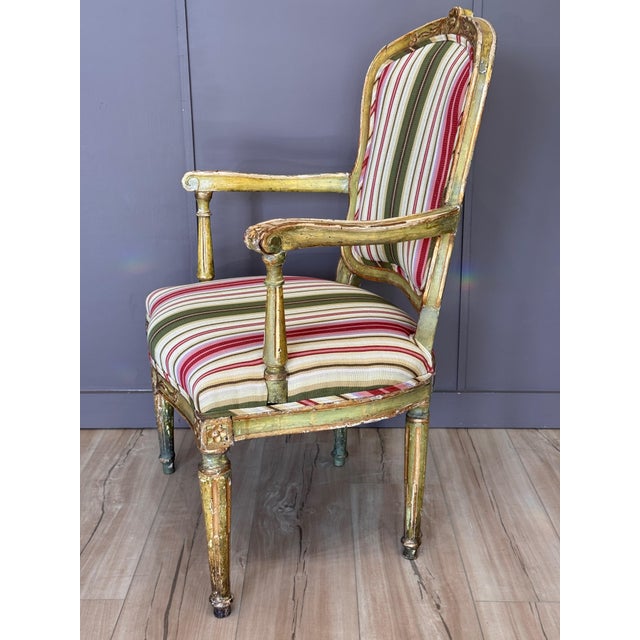 A late 18th century Italian classical armchair, retaining an appealing green painted and parcel-gilt surface. The frame...