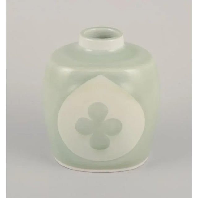 Nils Thorsson for Royal Copenhagen. Rare ceramic vase in celadon glaze. Motif of a four-leaf clover. 1930s/40s. Marked....