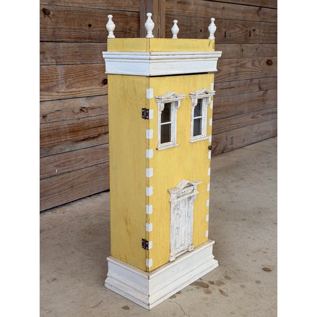 Charming and highly decorative, this vintage trompe l’oeil folk art cabinet is designed as a miniature architectural...