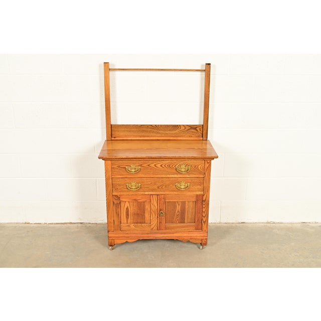 A gorgeous antique Victorian washstand or commode with towel rack In the era of Herter Brothers USA, Circa 1890s Carved...