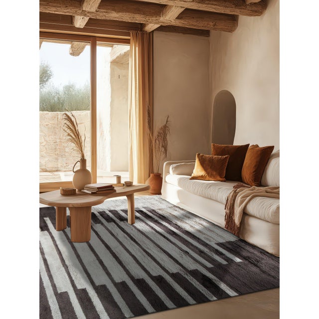 A hand-knotted wool rug, made in India and measuring 5' x 8'. Loose, abstract drawing rather than a formal repeating...