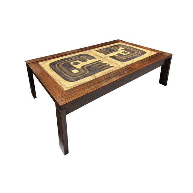 A Danish tile top coffee table attributed to Lysgaard Møbler circa 1960. Made of rosewood, inset with two identical,...