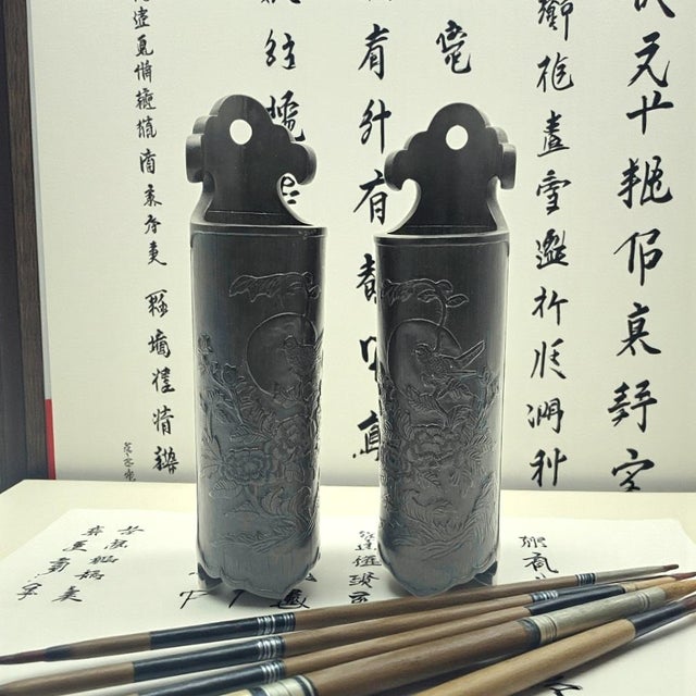 A matched pair of hand-carved hardwood wall cylinders featuring traditional Chinese sparrow and moon imagery framed by...