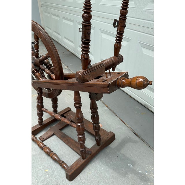 19th Century Spinning Wheel Small antique Saxony style oak spinning wheel. The historical, classic wheel is beautifully...