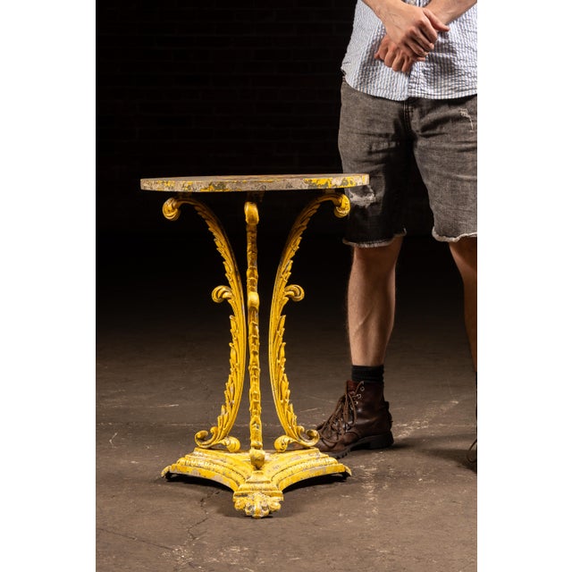 Cast iron conservatory table featuring a circular top supported by three finely cast pierced foliate-form legs terminating...