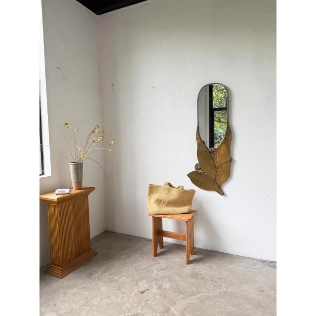 Large, elongated, handcrafted mirror with a floral motif – large hammered brass petals support a large oval mirror. we...