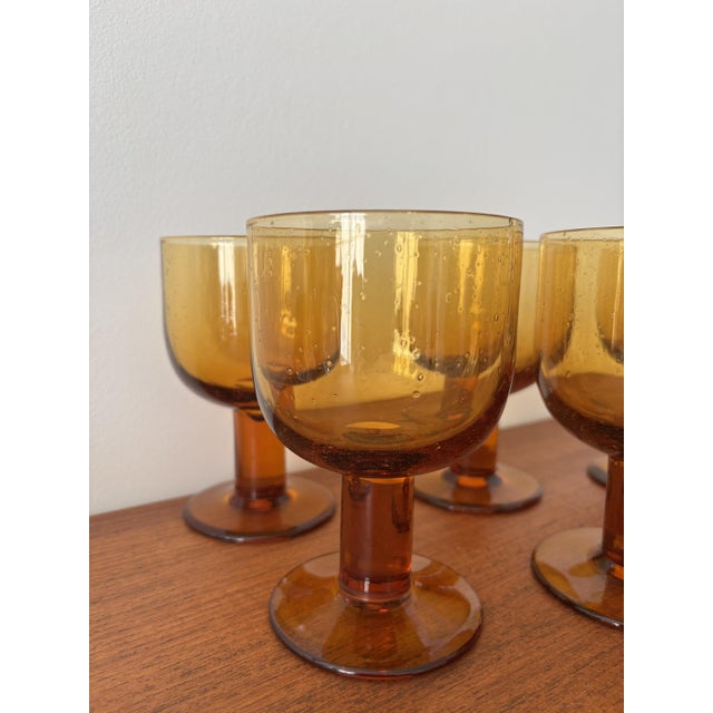 Charming set of 6 stemmed glasses in amber smoked glass with bubble inclusions. Their warm hue and slightly irregular...