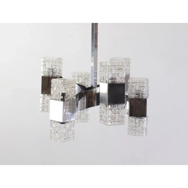 Chandelier by Gaetano Sciolari with six arms in chrome and glass. Uses twelve E14 light bulbs. This piece is attributed to...