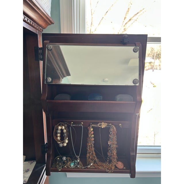 Lexington Cherry Petite Jewelry Armoire with inside light and mirror on inside of door. The light is pressure activated...