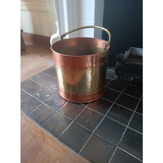 A substantial brass replace bucket, banded top and bottom with copper, and attractively studded along the seams with brass...