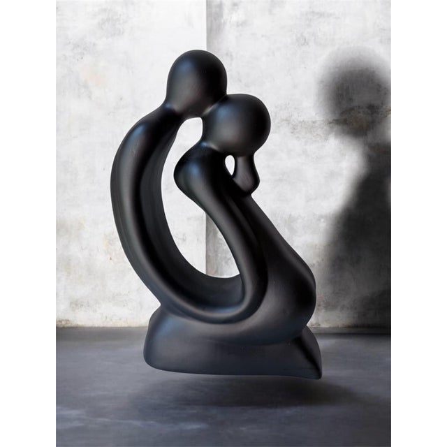 This modern minimalist sculpture, made in Portugal features a matte black finish and abstractly depicts a couple in an...