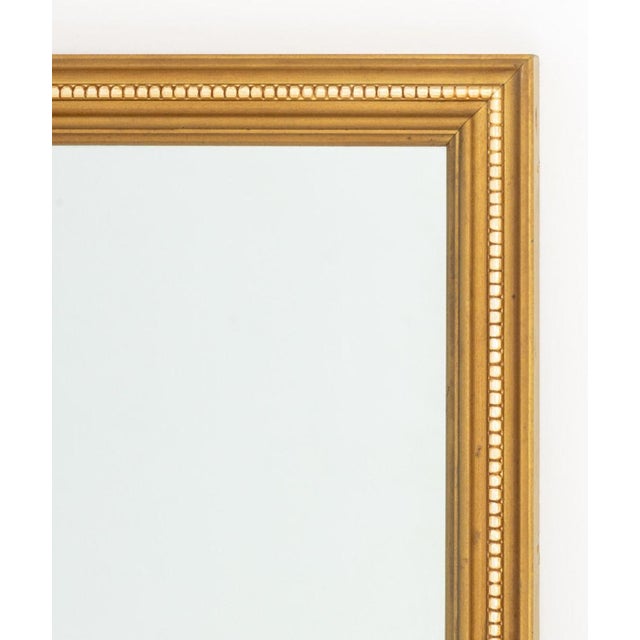 Neoclassical Style Giltwood Framed Mirror. Mirror: 26.5" H x 38.75" W; frame: 30" H x 42" W x 1" D. Provenance: From a...