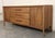 Long walnut dresser by Broyhill for their Emphasis line. Featuring nine total drawers. Two banks are concealed behind...