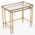 Pair of Italian brass nesting tables in the Hollywood Regency style, inspired by the work of Maison Baguès. The tables...