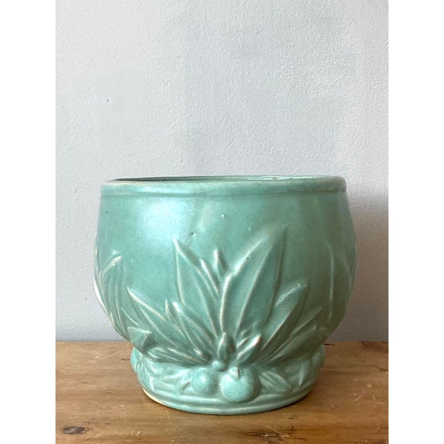This charming vintage cache pot is a quintessential example of mid-century American art pottery. Featuring a soft mint or...