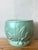 This charming vintage cache pot is a quintessential example of mid-century American art pottery. Featuring a soft mint or...