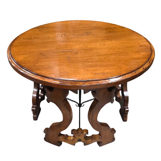 This Woodland Furniture “Aquitaine” Center Table is an engaging blend of sculptural woodwork and ornamental ironwork that,...