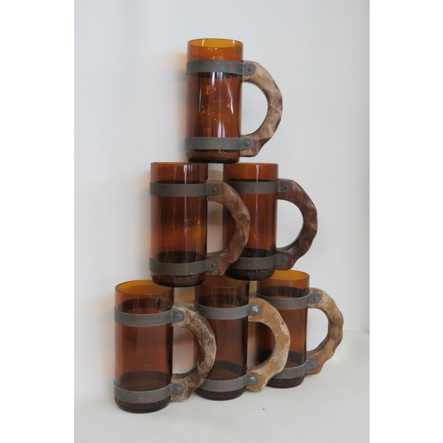 This charming Set of Beer Mug is made of glass, metal, and wood. Deep amber color, with beautiful patina around the the...