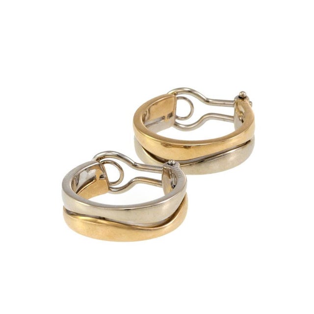 This is an authentic double wave bands hoop earrings by Cartier from the PUZZLE collection, they are well crafted from 18k...