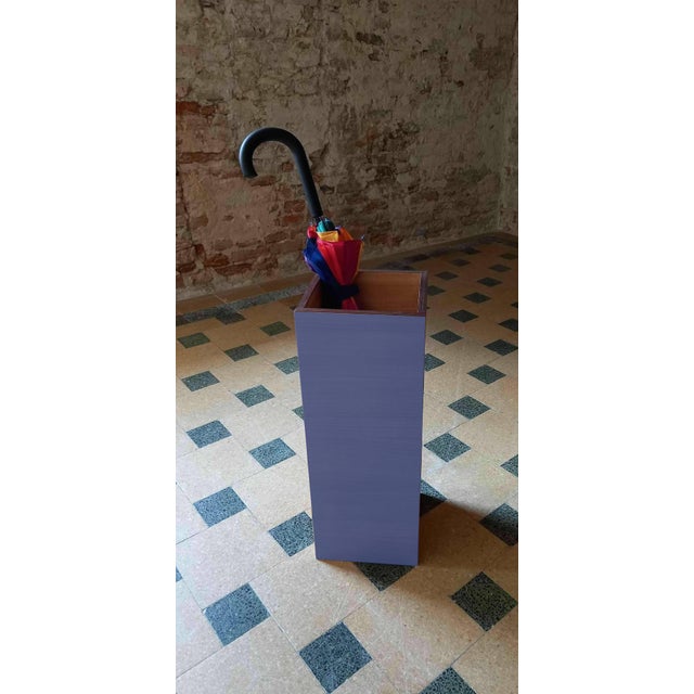 "Plinto Blu" umbrella stand by Pietro Meccani for Meccani Design. A stunning design piece crafted from light walnut with...