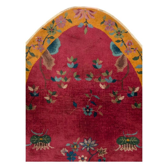 A vintage Chinese Art Deco accent rug, in an oblong oval shape, handmade during the mid-20th century with a floral pattern...
