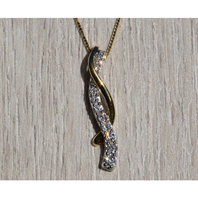 The Tarama: Ladies 14K Yellow Gold Twisted Diamond Journey Necklace. Crafted in 14 karat yellow gold, this ladies necklace...