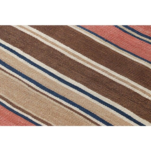 Made with handwoven wool in Persia circa 1950-1960, this 5x10 vintage Shahsavan Kilim runner is a particularly bright and...