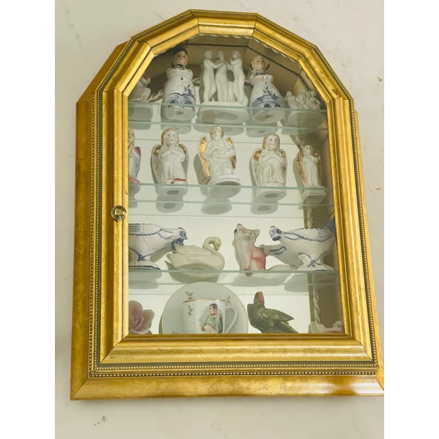 Splendid antique Austrian porcelain angels collection in a small wall vitrine display case.