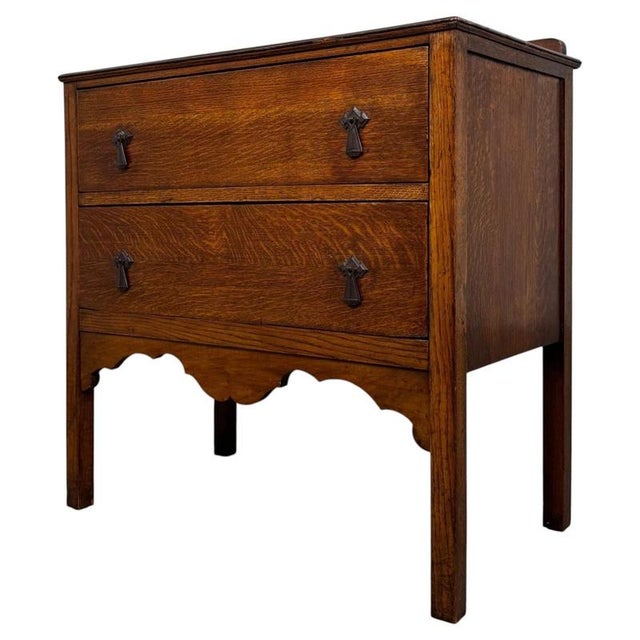 A charming and compact 20th-century golden oak chest of drawers, combining practical storage, traditional detailing and...