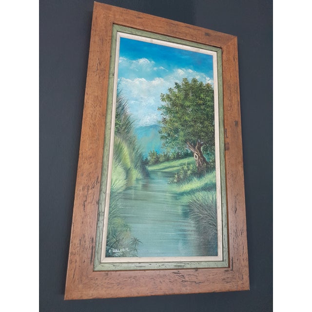 Framed oil on canvas painting by Errol Walker of a beautiful depiction of a Jamaica river surrounded by lush greenery and...