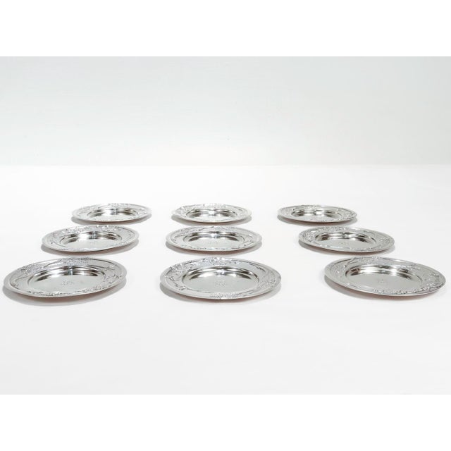 An extremely rare set of sterling silver butter pats. In the Vine pattern decorated with raised poppies and other flowers...