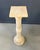 This elegant carved alabaster column features a classical architectural form rendered in softly veined, warm-toned stone....