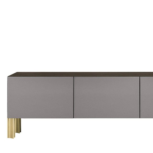 Defined by a sleek architectural silhouette, this living sideboard by Robert Stadler pairs a gray polished lacquered wood...