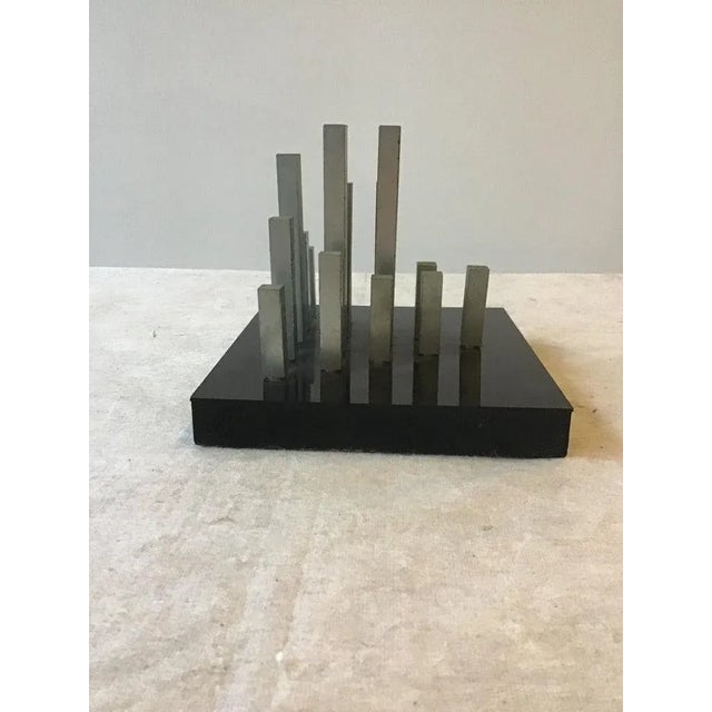 1960s skyline sculpture. Metal on granite base.