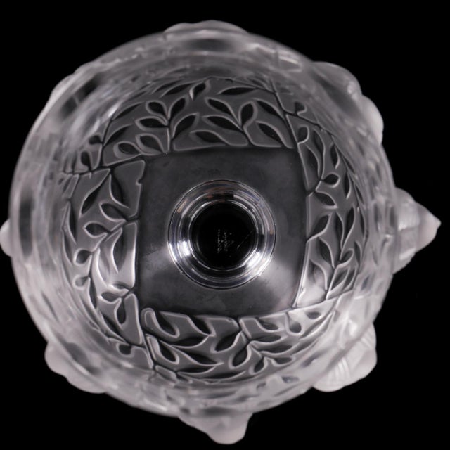 A signed Lalique France crystal vase in the Elizabeth pattern, featuring frosted birds and foliage wrapped around a clear...