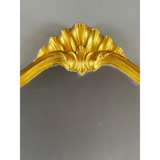 Elegant Rococo style wall mirror, dating from the 20th century, with a finely molded giltwood frame. The undulating border...