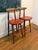 Mid-century counter stools are an iconic Danish design by Vilhelm Wohlert for Stolefabriken Odense, featuring a warm wood...