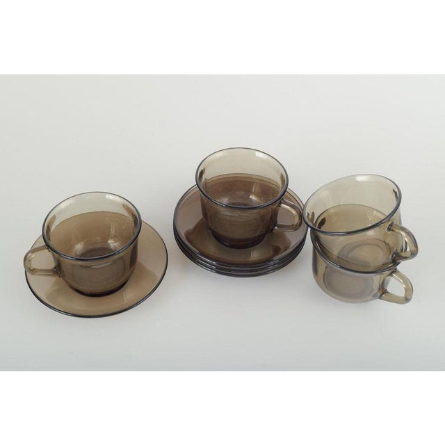 Vereco, France 4 cups with saucers, 1970s. Set of four cups and four saucers in smoked glass. A classic French design by...