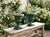 A pair of French green painted cast iron Medici style garden urn planters with green painted patina. Cast in two parts...