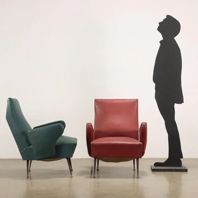 Pair of armchairs; spring padding, original period skai upholstery, metal legs. This piece is attributed to the mentioned...