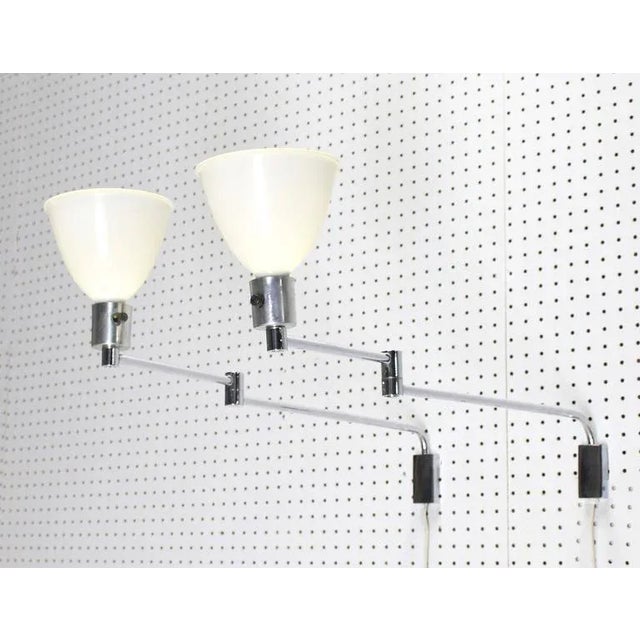 Pair of Mid-Century Modern adjustable chrome sconces. Perfect for a modern home.