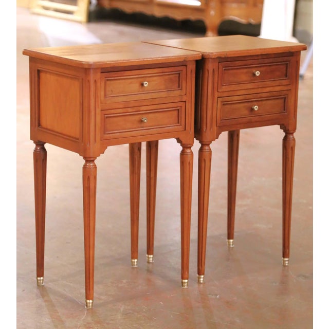 This elegant pair of Louis XVI style bedside tables was crafted in the late 20th century, circa 1980, and showcases...